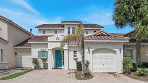 A two-story house with a tiled roof, a blue door, and a garage. - HOME SWEET HOME ! COMFY 4 BED 4 BATH SLEEPING 10  PRIVATE TUSCAN HILLS COMMUNITY (Davenport)