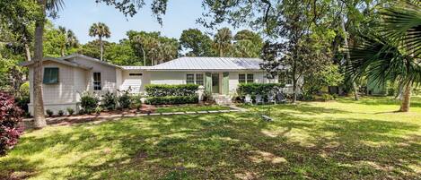 A single-story house with a front porch, a small attached garage, and a well-maintained lawn.