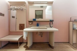 A bathroom with a sink, mirror, towel rack, bench, and a door leading to another room. - HanTing Hotel (Taizhou Sanmen) (Sanmen)