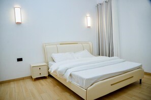 Cozy retreat with a single bed, bedside table, and wall-mounted light.