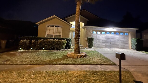 A residential house with a garage, a lawn, and a mailbox. - 8054 Hidden Gem (Kissimmee)