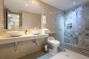 A modern bathroom with a large mirror, two sinks, a toilet, and a shower area. - Casa Vargas 6-77 By SoHo (Cartagena)