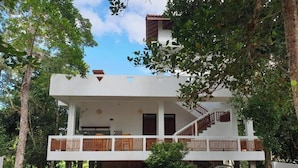 A two-story building with a balcony, a staircase, and a brick wall. - Cocosurf House (Hikkaduwa)