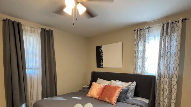 A bedroom with a bed, a ceiling fan, and curtains. - Charming Brand NEW  3B/2bathroom house closed by to all shopping and MUSC (Florence)