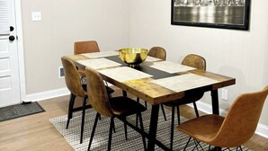 A dining room with a wooden table, four chairs, a large bowl, a ceiling fan, a framed clock, and a cityscape picture on the wall. - Charming Brand NEW  3B/2bathroom house closed by to all shopping and MUSC (Florence)