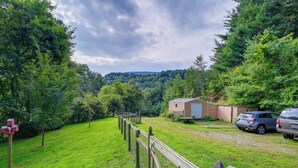 A fenced yard with a wooden deck, a shed, and two parked cars. - 2 Mi to Blue Ridge Pkwy! Mtn-View Sparta Retreat (Sparta)