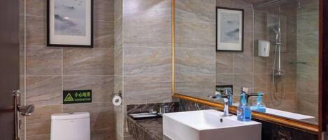 A modern bathroom with a marble sink, a toilet, and a shower.