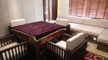 A dining area with a table, chairs, and a sofa.