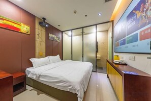 A hotel room with a bed, a desk, a mirror, a wall-mounted TV, and a sliding door leading to a bathroom. - Meicheng Hotel (Guangzhou Zhujiang New Town Subway Station) (Guangzhou)