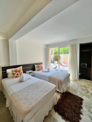 Habitación cuádruple, vista a la alberca | Caja de seguridad en la habitación, cortinas blackout y wifi gratis 