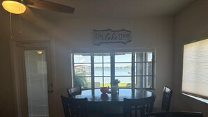 A kitchen with a large window, a dining table, and a stove. - Relaxing Lake Retreat (Lake Placid)