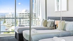 A hotel room with two beds, a large window with a city view, and a framed artwork on the wall. - 2 Bed 1 Bath Apartment at Chevron - Q Stay (CHEV 3107 - 2N - NB) (Surfers Paradise)