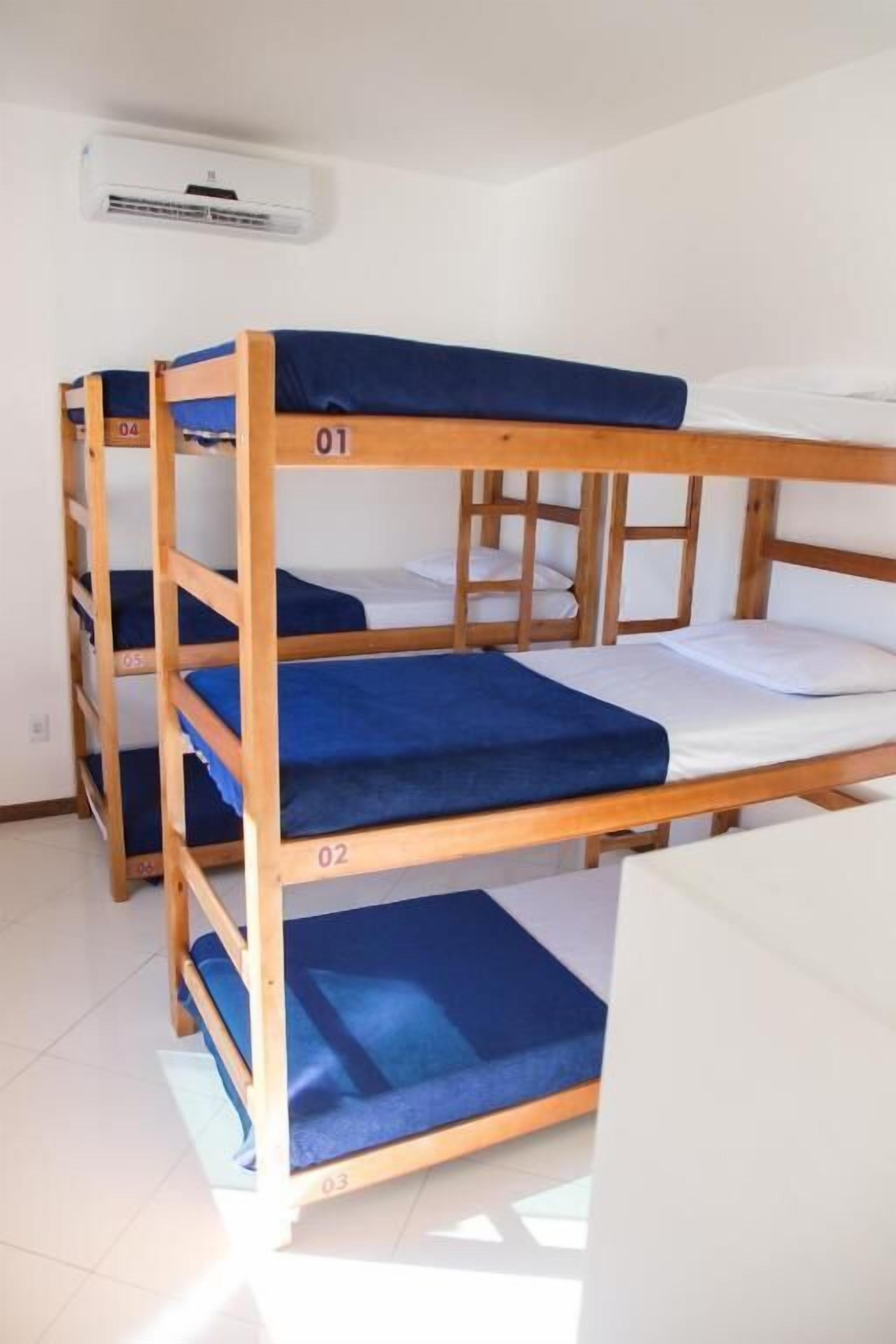 A bunk bed room with three levels, numbered 01, 02, and 03.