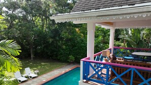 A pool area with a covered seating area and chairs. - Charming 3-bedroom Gingerbread Style Villa in Bon Accord, Tobago (Bon Accord)
