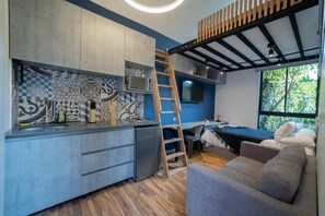 Apartment (A106) | Private kitchen | Mini-fridge, microwave, stovetop, cookware/dishes/utensils - Aguacatala by Roots Rentals (Medellín)