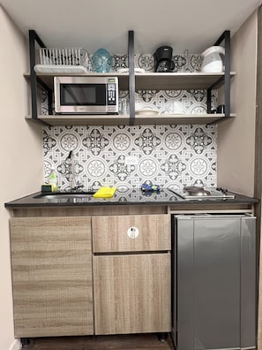 Apartment (A104) | Private kitchen | Mini-fridge, microwave, stovetop, cookware/dishes/utensils - Aguacatala by Roots Rentals (Medellín)
