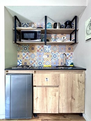 Apartment (A103) | Private kitchen | Mini-fridge, microwave, stovetop, cookware/dishes/utensils