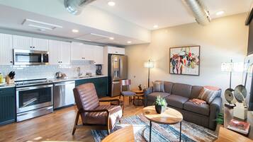 A modern apartment with a kitchen, living room, and dining area.