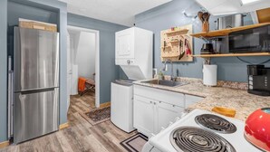 A compact kitchen with a stainless steel refrigerator, white cabinets, a microwave, and a red kettle. - 2-bedroom cabin with hot tub near George Washington National Forest (Mount Jackson)