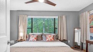 A bedroom with a bed, curtains, a window with blinds, a ceiling fan, and a bedside table with a lamp. - 2-bedroom cabin with hot tub near George Washington National Forest (Mount Jackson)