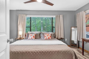 A bedroom with a bed, curtains, a window with blinds, a ceiling fan, and a bedside table with a lamp. - 2-bedroom cabin with hot tub near George Washington National Forest (Mount Jackson)