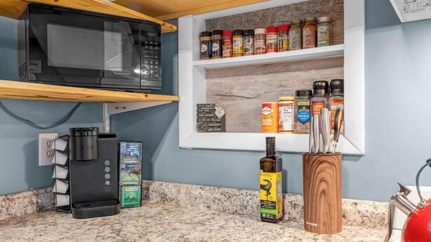 A kitchen with a microwave, coffee maker, and a spice rack. - 2-bedroom cabin with hot tub near George Washington National Forest (Mount Jackson)