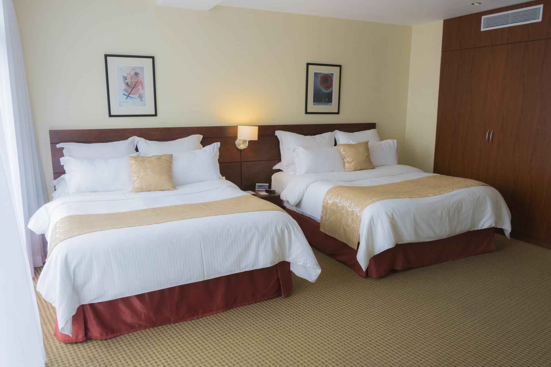 Deluxe Quadruple Room, Balcony, City View | Minibar, in-room safe, desk, laptop workspace