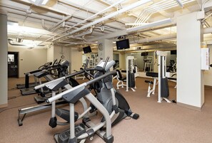A gym with treadmills, elliptical machines, and weight equipment. - Spacious 2BR 2BA with Parking, Gorgeous Skyline View, and Direct Skywalk Access! (Des Moines)