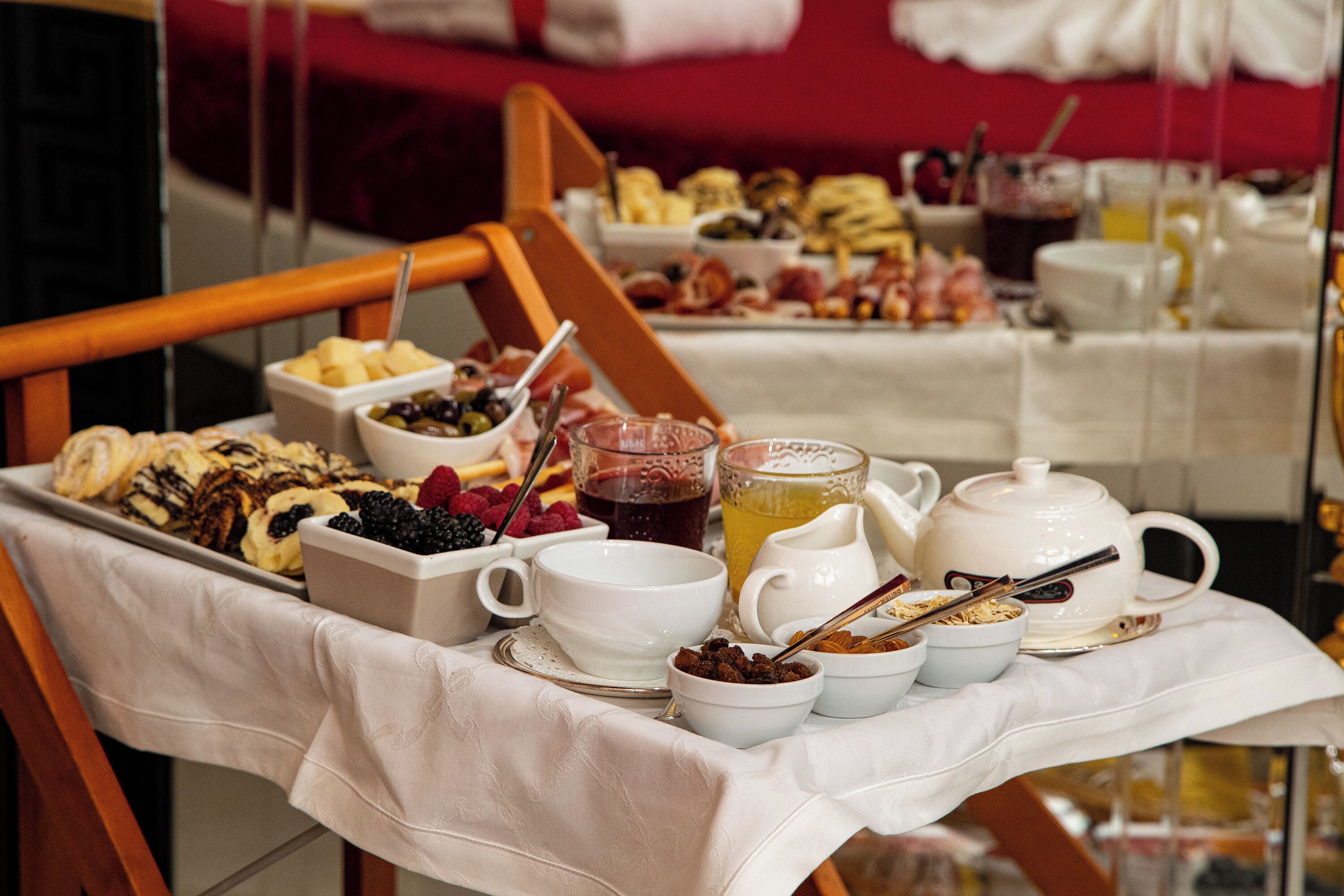 A breakfast buffet with various food items and beverages on a table.