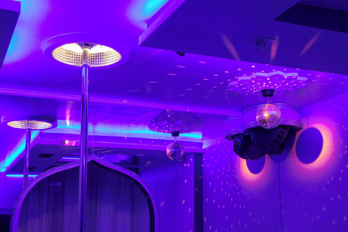 A room with a modern ceiling design featuring recessed lighting and decorative elements.