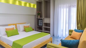 A hotel room with a bed, a seating area, a bookshelf, and a window with curtains. - Maison Matie B&B Ercolano (Ercolano)