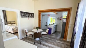 A compact kitchen with a dining area, a bed, and a small kitchenette. - Newly Remodel Duplex Free Parking 3-Bed-1 Bath. (Sacramento)