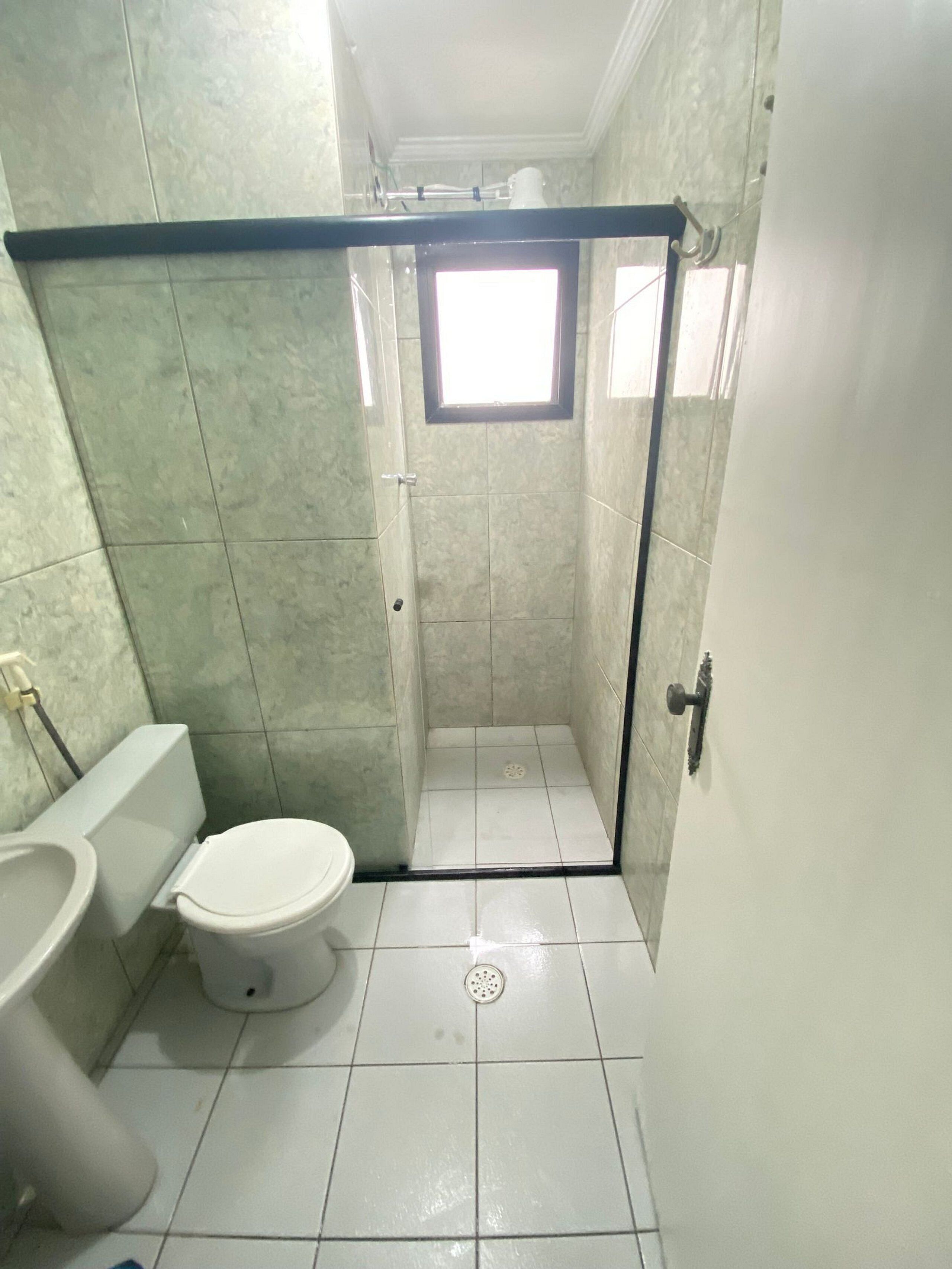 A small bathroom with a toilet, a urinal, and a shower stall.