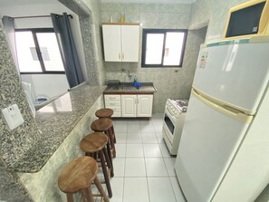Apartment | Private kitchen | Cookware/dishes/utensils, dining tables - Pé na Areia Praia da Ocean (Praia Grande)