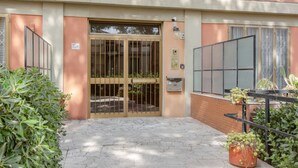 A building entrance with a gated door, a mailbox, and potted plants. - GuestHost - Modern 75 sqm apartment, able to comfortably accommodate up to 4 people, located on the second floor of a building with lift (a few steps to reach the lift). The property is located in the San Jacopino area, a lively neighborhood well connect (Firenze)