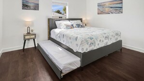 A bedroom with a bed, nightstands, and a window. - Experience paradise! Three bedrooms in Fort Myers Beach accommodation up to 10+  (Fort Myers Beach)