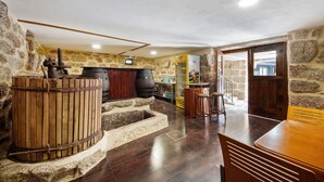 A rustic interior with stone walls, wooden barrels, and a bar area. - Room 4 with private bathroom, Wi-Fi and air conditioning (Rossas)