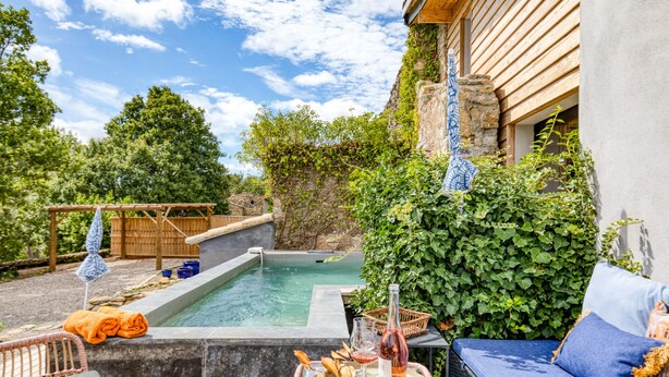A pool area with a hot tub, lounge chairs, and a table with drinks and snacks. - Le Mas De Coeur with Mountain View, Wi-Fi and Air Conditioning (Bédarieux)