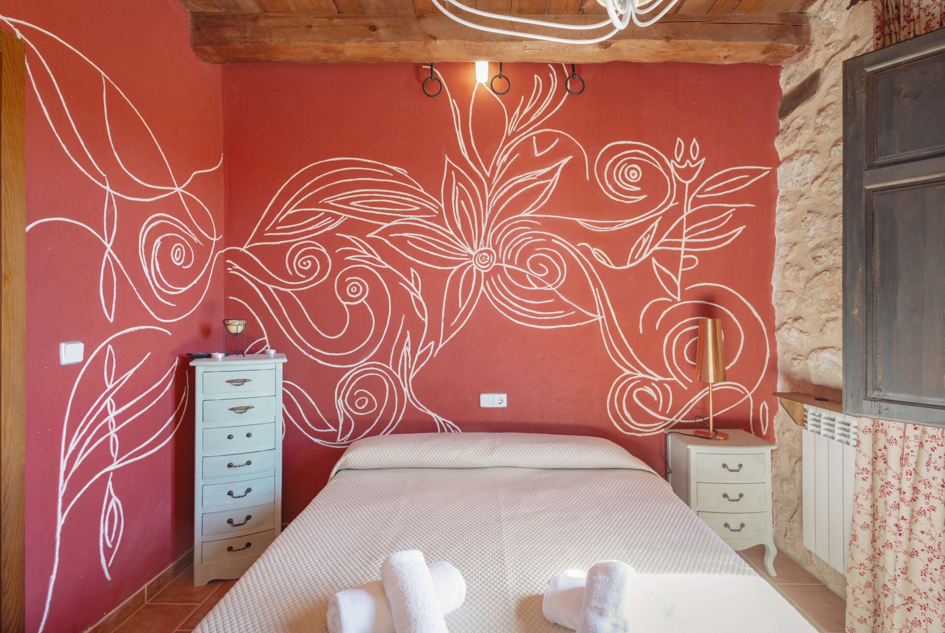 Un dormitorio con una cama, un aparador y una mesita de noche.