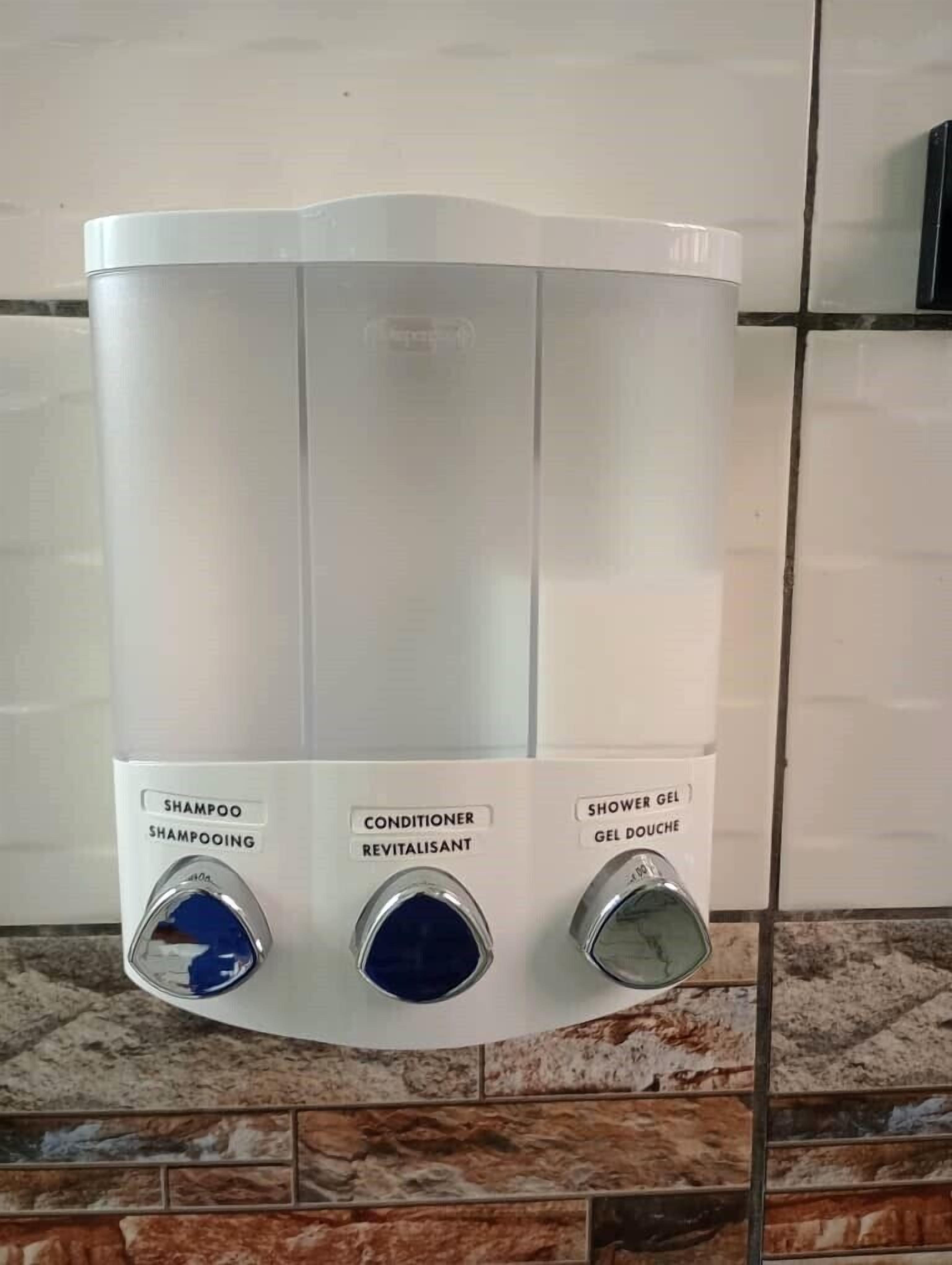 A bathroom with a white dispenser for shampoo, conditioner, and shower gel.