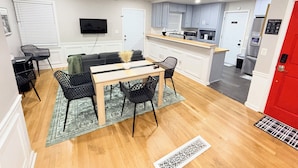 A modern kitchen with grey cabinets, a microwave, and a refrigerator. - Cozy 3BR Retreat • Near ATL Airport & Downtown (Conley)