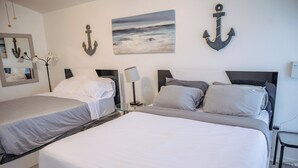 A hotel room with two beds, a large painting of a seascape, and two anchors on the wall. - Emely's place 

5 minutes from Jacksonville international airport (Jacksonville)