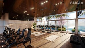 A modern gym with exercise equipment, large windows, and a view of the ocean. - The Song Vung Tau Apartment (Ho Chi Minh City)
