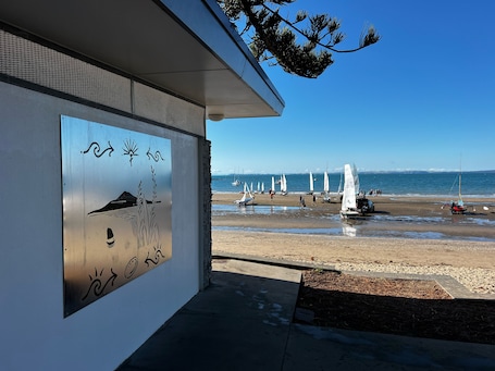 Beach nearby, white sand, sun-loungers, beach towels. Waiake Beach Apartments