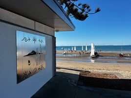 Beach nearby, white sand, sun loungers, beach towels
