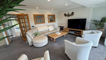 Deluxe Apartment, Non Smoking, Park View | Living area | 65-inch flat-screen TV with digital channels, TV, fireplace
