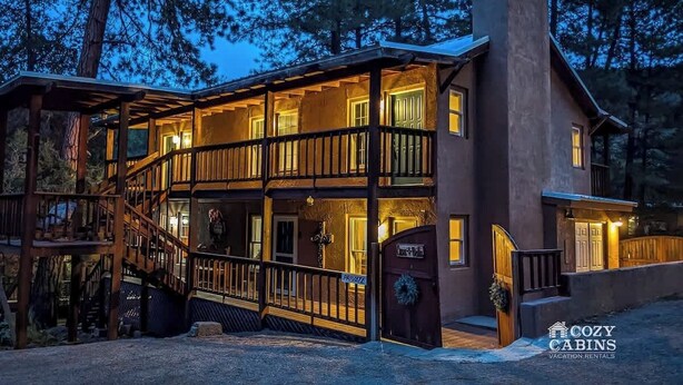 A two-story cabin with a balcony, a staircase, and a private entrance. - Casa Bella 6 Bedrooms (Ruidoso)