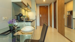 A modern kitchen with a dining area set for a meal. - Luxury Everything Walking Distance c112 (Rawai)