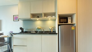 A modern kitchen with a stainless steel refrigerator, a microwave, and a sink. - Luxury Everything Walking Distance c112 (Rawai)