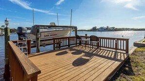 A wooden dock with a boat named 'Super Paradise' docked at the pier. - Waterfront with Pool, Ping Pong table, 3 Kayaks, Fishing Pier, Private Access to the Gulf (Port Richey)